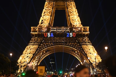 Man beklimt Eiffeltoren met Amerikaanse vlag en wordt opgepakt