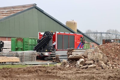 Man raakt bekneld tussen hoogwerker en schuur